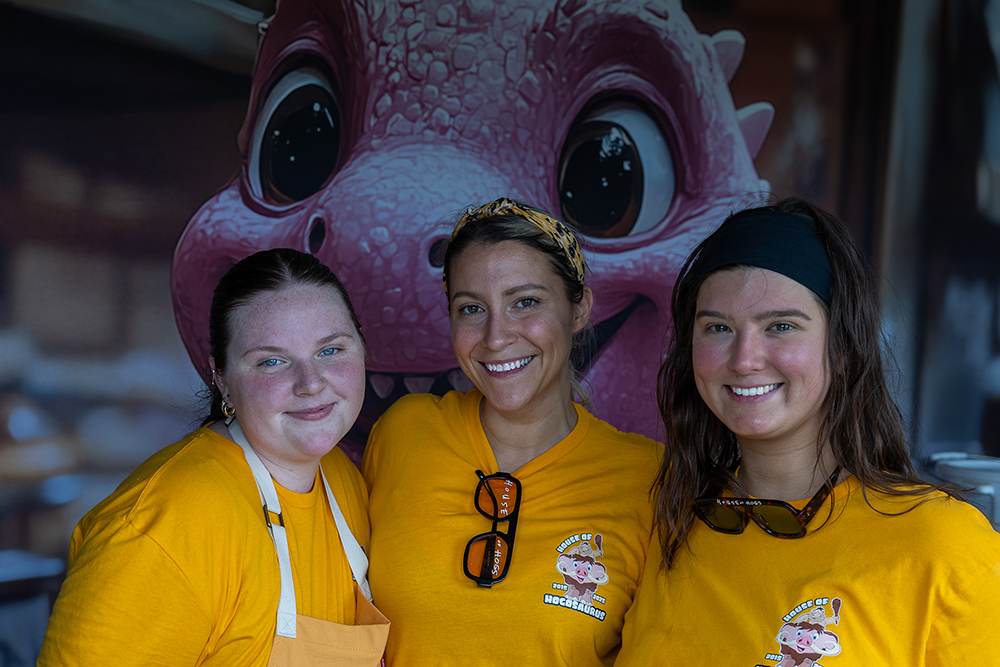 Two young girls smiling at a House of Hogs event booth