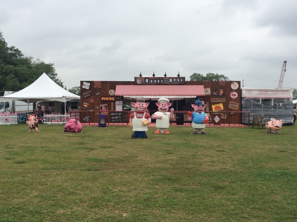 The first House of Hogs booth at Hogs for the Cause in 2016, with three pig characters out front