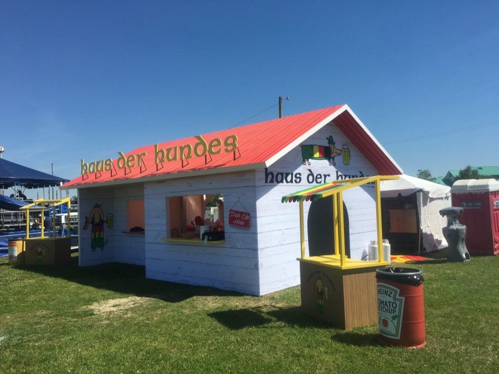 The 2018 Haus der Hundes German beer-hall themed booth with a dachshund mascot