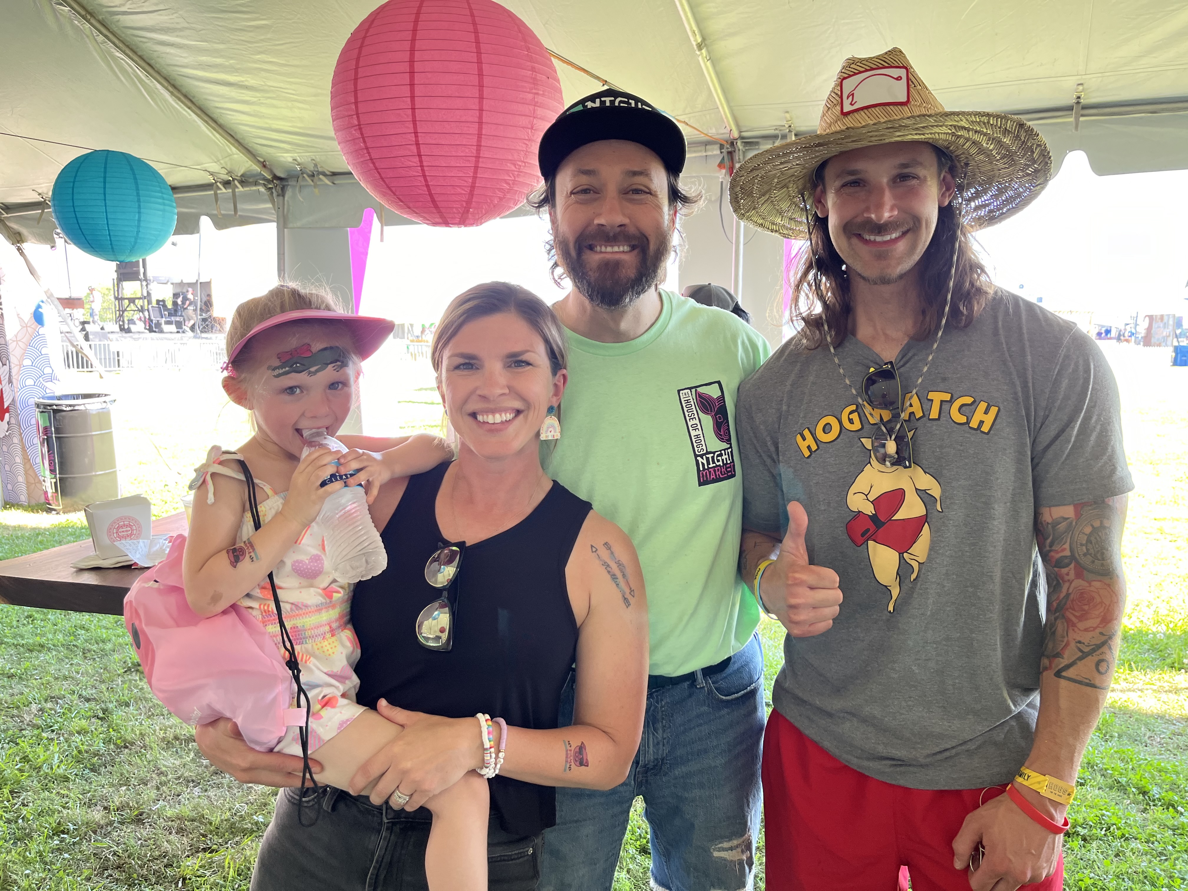 A family with the House of Hogs team at the 2026 booth