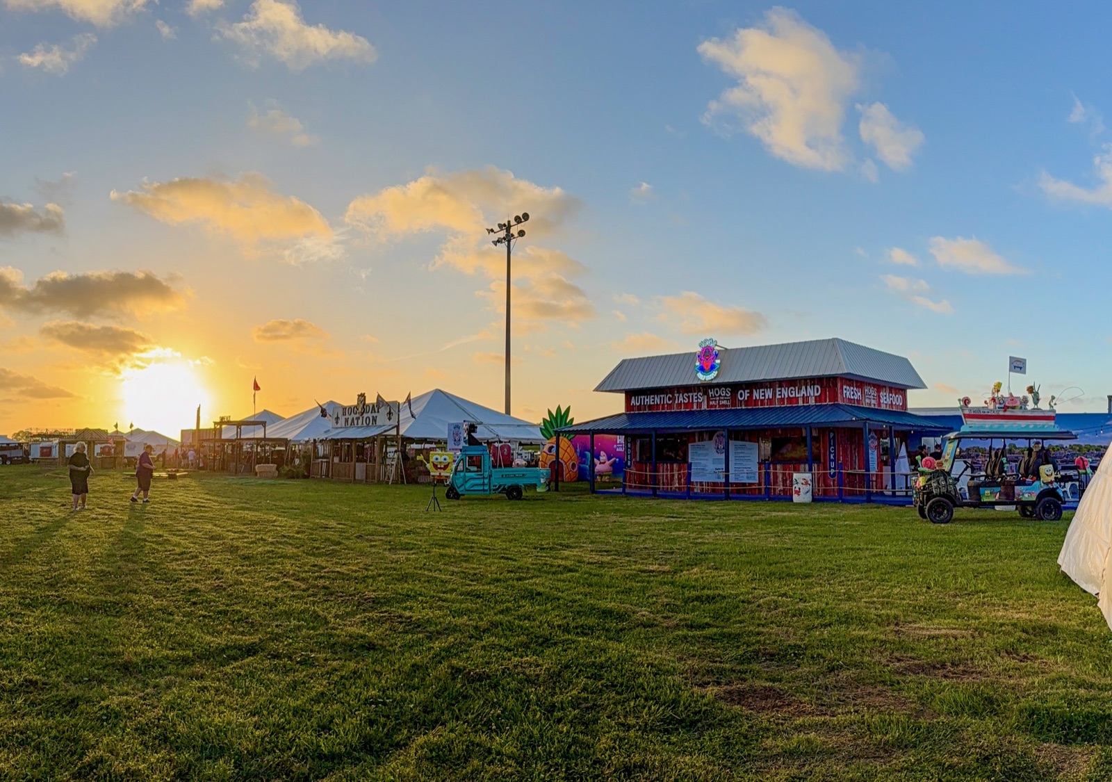 The Hogs on the Half Shell booth at sunset