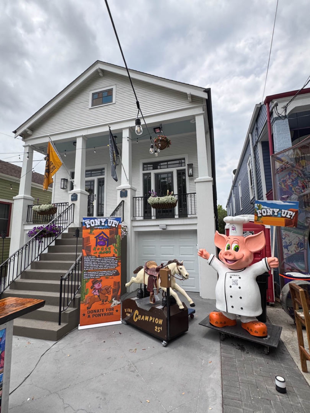 The Pony Up kiddie ride and chef-pig mascot at Jazz Fest on Esplanade