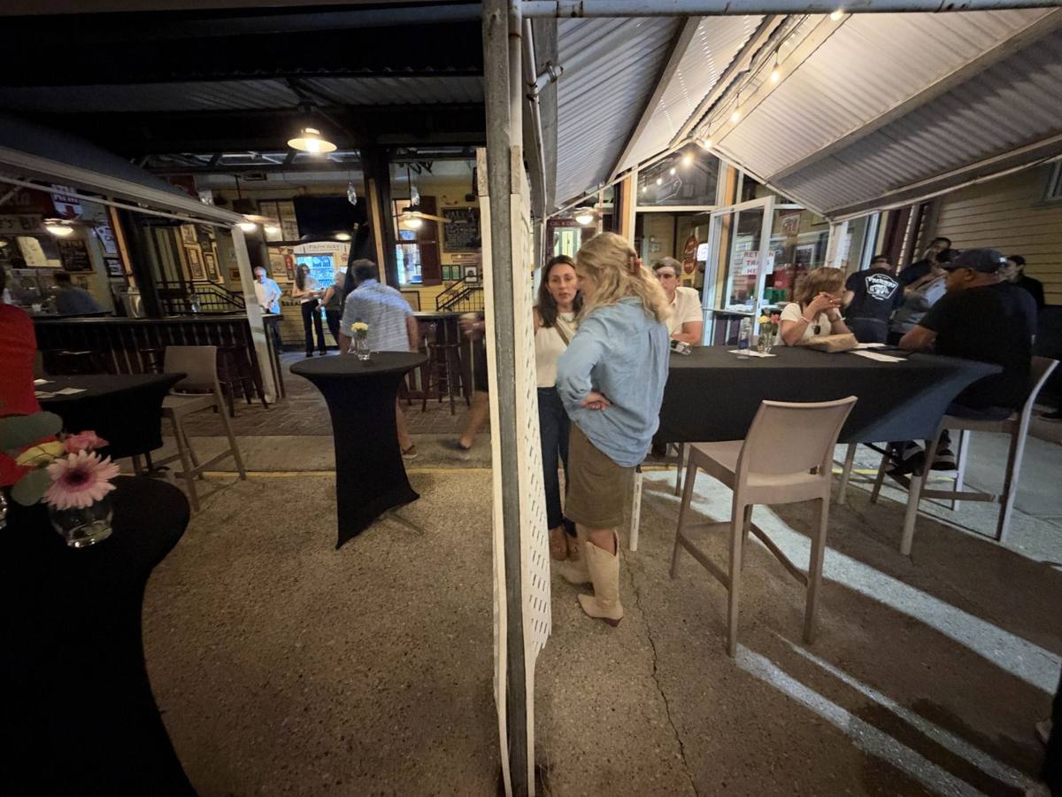 Cocktail tables set up under the string lights in Parkway's courtyard