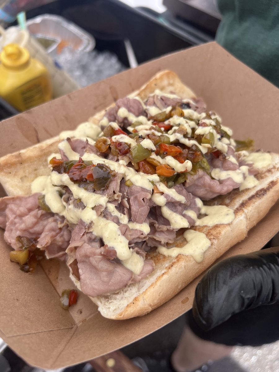An Italian beef piled with giardiniera, sweet peppers, and a cheese drizzle at our Washoe Park booth