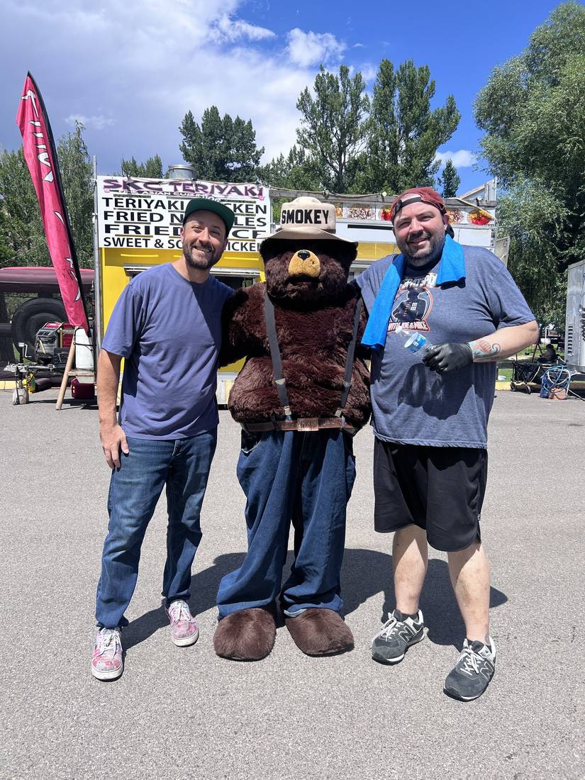 House of Hogs teammates posing with Smokey Bear at Art in Washoe Park