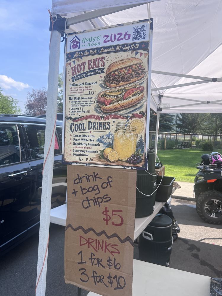 Hand-drawn booth signs listing drink deals and combos
